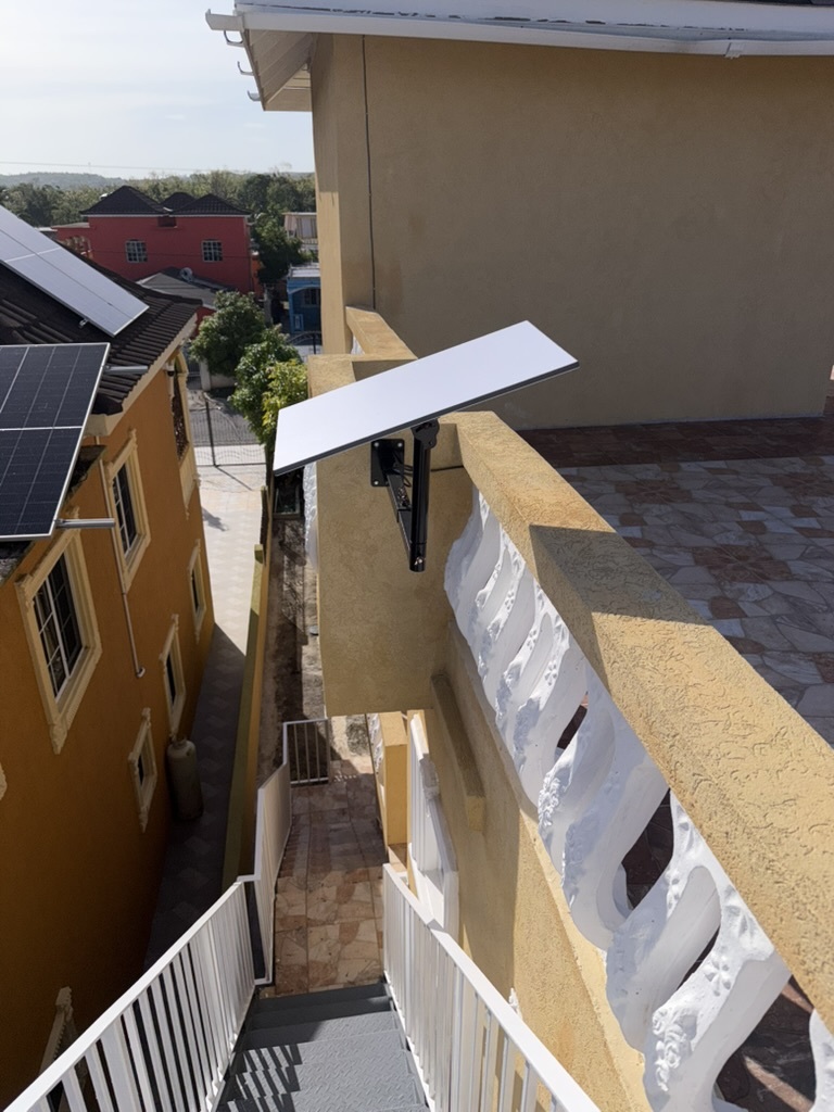 Starlink dish wall-mounted on balcony — CoreBridge Tech Ltd install