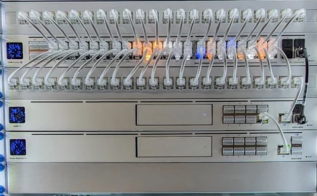UniFi wall-mount rack with APC UPS, switches and Dream Machine — clean cable management